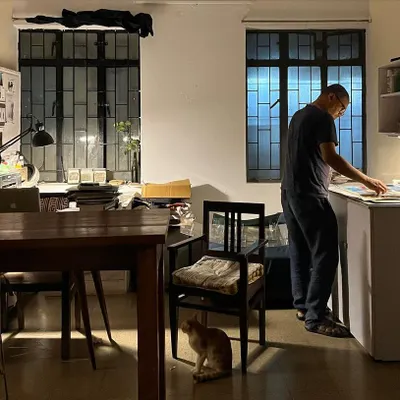 A quiet evening at the studio, where an artist works late into the night, with Julie the cat keeping watch. Our space nurtures both collaboration and the solitude required for deep creative work.