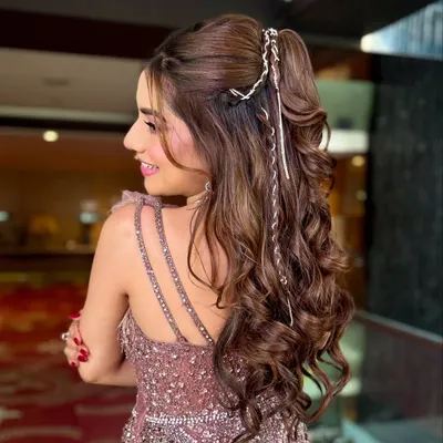 A high-glam ponytail with voluminous curls, perfect for a cocktail or sangeet night. I added a delicate silver braid wrap to give this fun style an extra touch of sparkle.