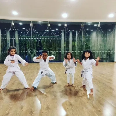 Say hello to some of my four-year-old warriors. In our indoor studio, I encourage them to be expressive and find their own powerful poses. This is beginner karate for preschoolers, where fun comes first.