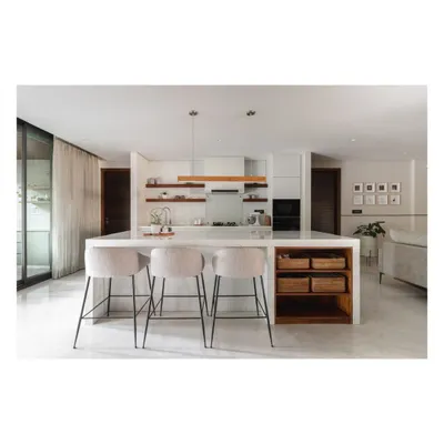The heart of this home is the open-plan kitchen and dining area. A large marble island with bar stools serves as a casual spot for breakfast and conversation, connecting directly to the more formal dining space.