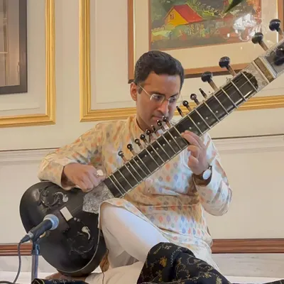 Performing at a private 'Baithak' style house concert. This intimate setting allows for a deep connection with the audience and a truly personal musical journey.