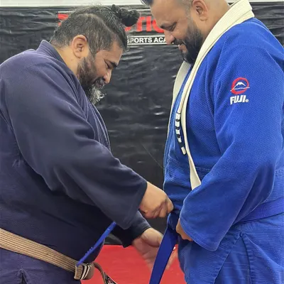 Level up. The moment a student earns their blue belt in Brazilian Jiu-Jitsu. This is a significant milestone, representing countless hours of dedication and learning on the mats.