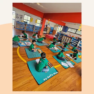 This is the beautiful result of a prepared environment. Children working independently, respecting each other's space, and fully absorbed in their tasks. This is success in a Montessori classroom.