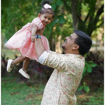 A joyful moment between a father and his daughter during an outdoor family shoot. Lifting her up in the air always brings out the biggest smiles and creates a dynamic, loving photo.
