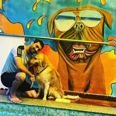 Bruno and his human sharing a quiet moment by the pool. Our space is designed for pet parents to bond with their furry kids.