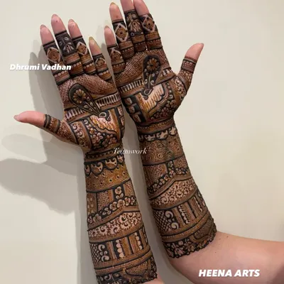 A gorgeous full-arm mehendi for the groom's sister. The design is intricate and celebratory, perfect for a close family member.