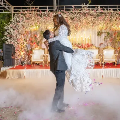 A truly magical first dance. The groom lifts his bride against a backdrop of sparklers and smoke, creating a cinematic moment that feels straight out of a movie. This is what I mean by an epic wedding reception.