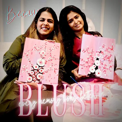 "Every memory looks better in Blush." Two friends proudly holding up their beautiful textured cherry blossom paintings.