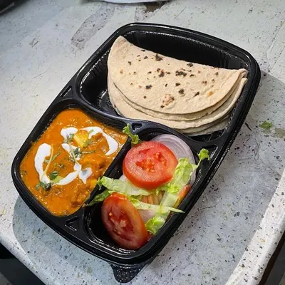 A delicious Shahi Paneer meal, complete with a creamy tomato-based gravy, served with soft rotis and a fresh garden salad. This is a rich and satisfying option for your daily lunch.