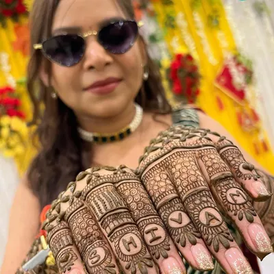 A creative way to add a personal touch! This client wanted the name 'SHIVAM' incorporated into her finger designs for her special day.