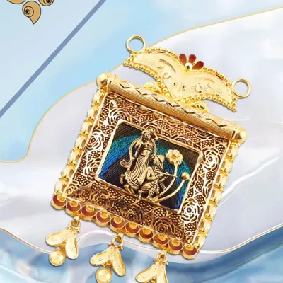 An intricate gold pendant featuring a traditional motif with delicate enamel work. This piece is a perfect example of our detailed craftsmanship and artistic design.