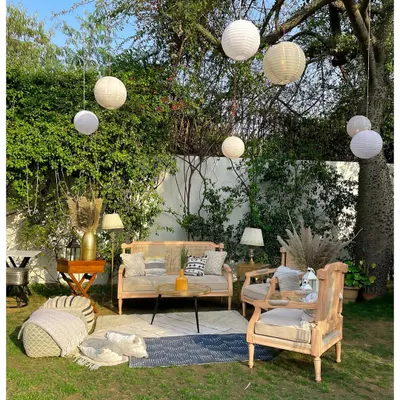 I create comfortable and stylish networking spaces, like this boho-chic outdoor lounge. The blend of natural wood furniture, soft textiles, and ambient paper lanterns provides a relaxed yet elegant setting for guests to connect.