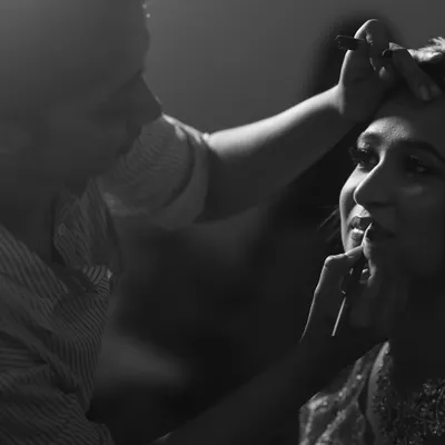 A quiet moment of focus. This black and white shot captures me applying lipstick, a crucial final step in creating the perfect bridal look.