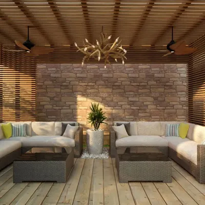 This outdoor seating area shows how texture and materials can define a space. The combination of a rough stone wall, smooth wooden decking, and comfortable wicker furniture creates a rich, tactile experience.