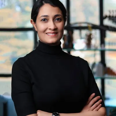 A classic professional headshot with a friendly and confident expression. The clean, out-of-focus background keeps the attention on the subject.