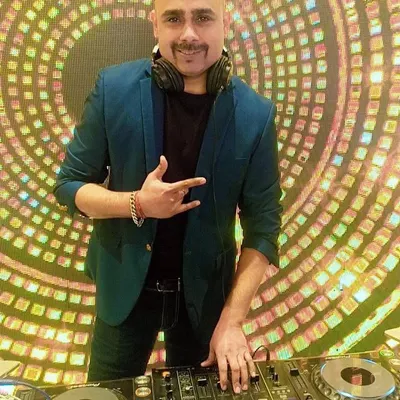 A clear, happy shot of me at my Pioneer DJ console, ready to get the party started. I believe a DJ's energy is just as important as the music they play.