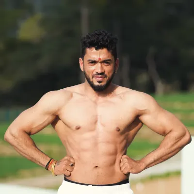 A confident outdoor physique shot. This is the look of strength and health that my coaching program helps you build.