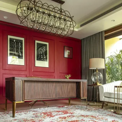 For our Barkat residence, we designed this bespoke desk and paired it with a bold red wall to create a powerful and inspiring home office. Each piece is crafted in collaboration with local artisans to be both functional and a work of art.