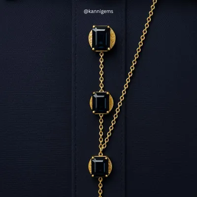 I transform functional details into statements of personal style. This custom button chain, featuring emerald-cut gemstones set in textured gold, is a bespoke creation for a formal shirt or kurta, showcasing how true luxury lies in the details.