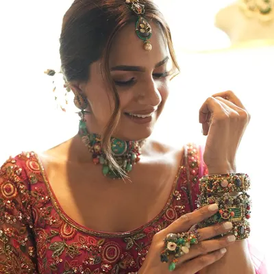 Inspiring brides, one collaboration at a time. A behind-the-scenes shot from a creative shoot, pairing a Ridhi Mehra fuchsia lehenga with eclectic jewelry from Purab Paschim.