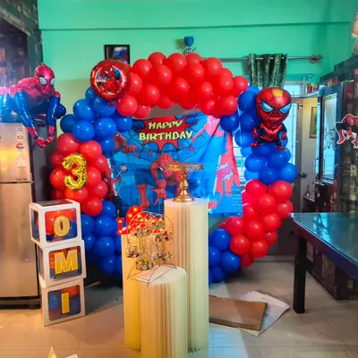 I can bring any superhero theme to life for your child's party. This Spiderman setup includes a classic red and blue balloon arch, a city-scape backdrop, and a large inflatable Spiderman figure to complete the action-packed look.
