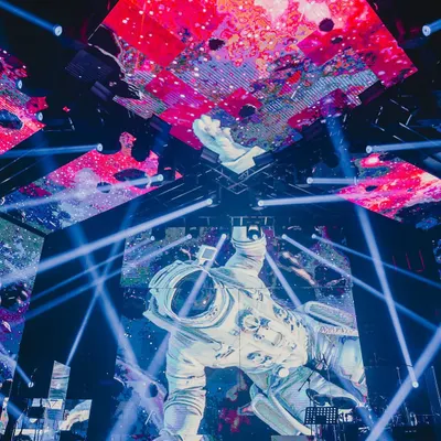 We rolled out the entire universe for this one. A massive astronaut figure floats above the stage, surrounded by cosmic visuals and laser beams, showcasing our commitment to boundary-pushing production design.