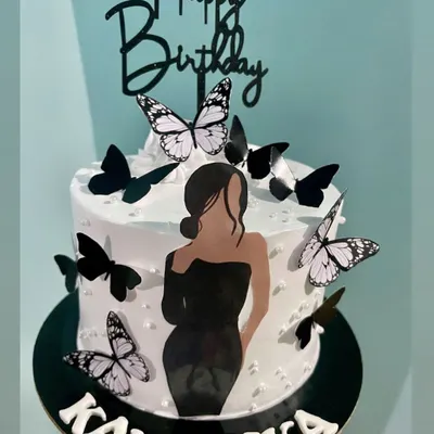 This cake combines two popular trends: a minimalist silhouette and delicate butterflies. The elegant black dress illustration paired with black and white butterflies creates a modern and fashionable birthday cake.