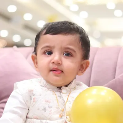 A beautiful, clear close-up portrait of a baby boy. His innocent expression and bright eyes are the focus of this simple and classic baby photo.