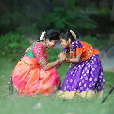 A beautiful moment between a mother and her daughter, both in our custom designs. I created her Pattu Pavadai to complement her mother's elegant saree, making their bond shine even brighter.