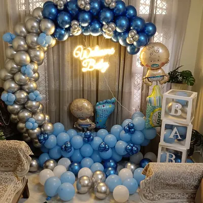 A complete 'Welcome Baby' decoration package for a home. This setup features a full circular balloon arch in metallic silver and blue, a neon sign, 'BABY' blocks, and several themed foil balloons to celebrate the new arrival.