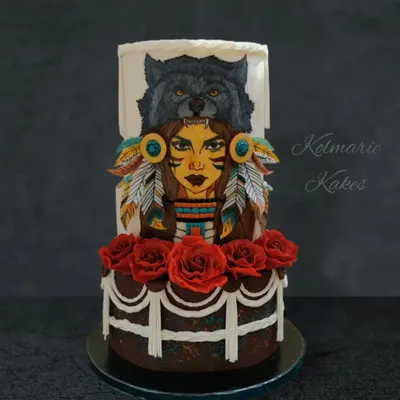 This cake features a detailed, hand-painted portrait of a Native American woman. I used edible paints to bring the image to life and complemented it with edible wafer paper feathers and sugar roses.