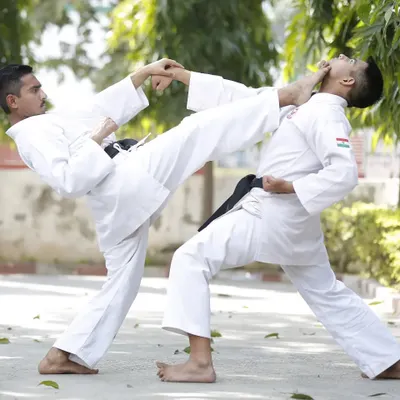 A demonstration of a controlled kick during a Kumite (sparring) practice session. These drills are essential for learning how to apply techniques effectively in a real situation.