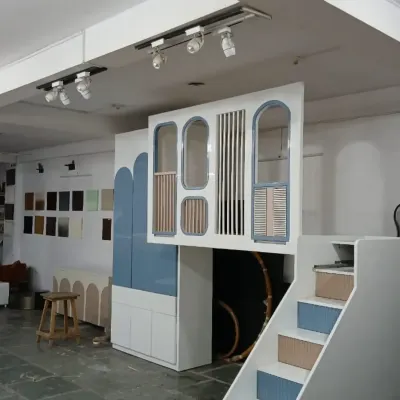 A wider view of the custom loft bed in our workshop, showing the stairs and the integrated wardrobe. This all-in-one solution is designed to maximize floor space while creating a fun and imaginative environment.