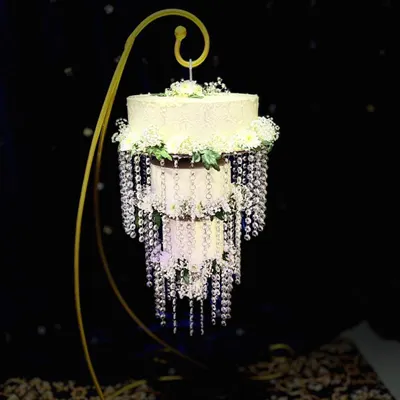 My signature chandelier wedding cake. This design hangs elegantly from a custom stand, adorned with cascading crystals and fresh flowers, creating a breathtaking centerpiece that appears to float in mid-air.