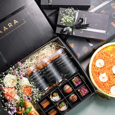 Our Sancho Box is the ultimate Diwali indulgence. It combines a box of our signature sweet bites with savoury jars, a freshly baked bread loaf, and fresh flowers, all presented in our elegant black CAARA box.