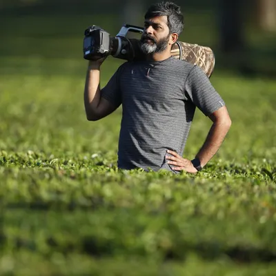Out in the field, surrounded by the tea gardens of the Western Ghats. Carrying a heavy lens is part of the job, but the results are always worth the effort.