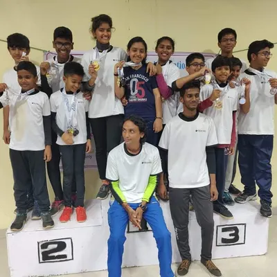 A proud moment with my young champions on the winner's podium. This image celebrates the multiple medals won by our shooters, showcasing the depth of talent nurtured at my academy.