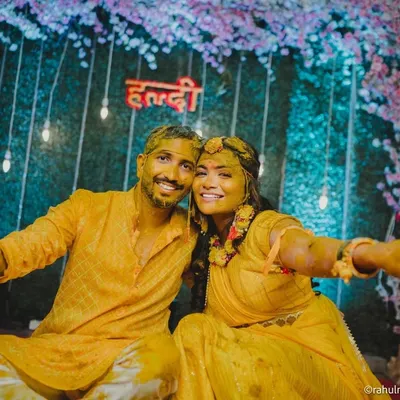 A fun-filled shot of the couple covered in turmeric paste, posing happily after their Haldi ceremony.