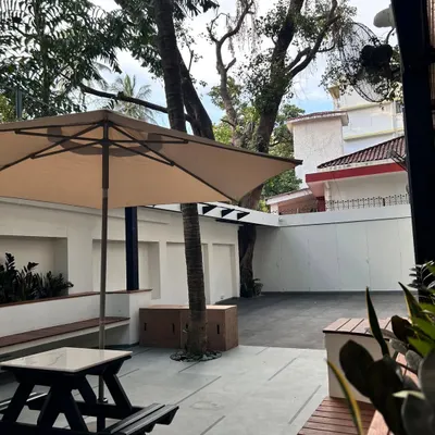 A glimpse of our renovated outdoor garden. We poured a lot of sweat into creating this green, open-air space for our community to train, relax, and connect.
