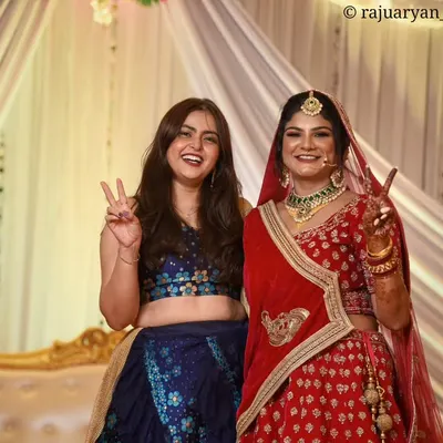 The bride sharing a moment of pure joy and fun with her bridesmaid. Capturing these candid interactions with friends and family is an essential part of the wedding story.