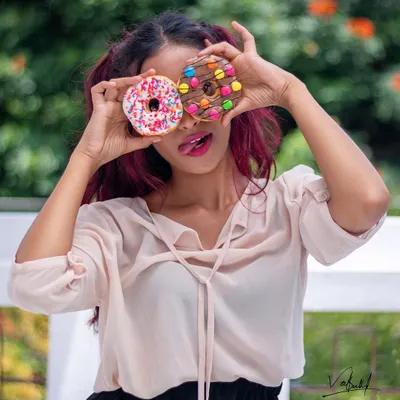 Peek-a-boo with donuts! This playful and colorful shot is from a fun lifestyle session. Using props like these is a great way to bring out a model's personality and create joyful, authentic moments.