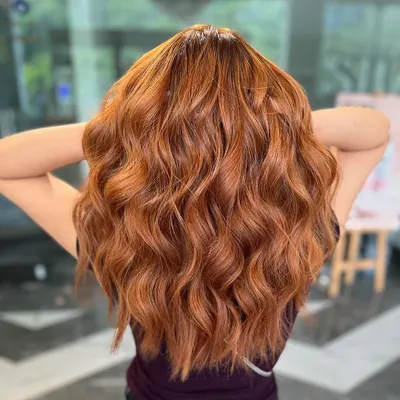 A vibrant copper balayage that is fiery and full of personality. This color is perfect for making a bold statement.