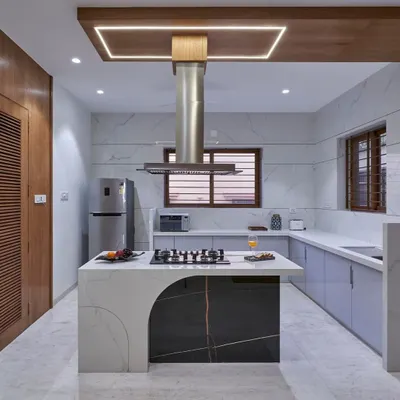 This kitchen is the heart of the home, designed for both serious cooking and casual gatherings. The statement island with an integrated cooktop, marble finishes, and custom cabinetry combines high functionality with a sleek, modern aesthetic.