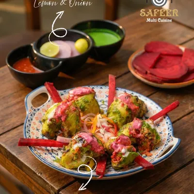 Our Pink Parrot Chicken is a visually stunning starter. Tender chicken pieces are marinated in a green masala, grilled, and then drizzled with a vibrant pink sauce, creating a unique and delicious flavor combination.