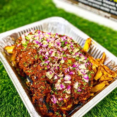 My showstopping Mutton Sikandari Raan. A whole leg of lamb is marinated for hours and slow-cooked until it's incredibly tender, then garnished with rose petals. It's a true centerpiece for any grand celebration.