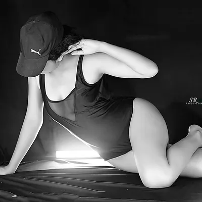 A bold, monochrome shot using a single light source to create a dramatic, high-contrast look. This is perfect for an edgy fitness or fashion portfolio.