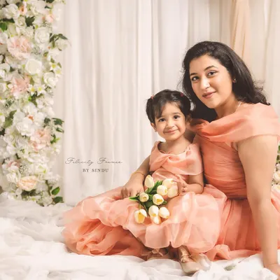 Creating memories stitched with love. This enchanting mother-daughter duo, Meghana and her little one, are twinning in elegant peach organza gowns I designed for their special Mother's Day photoshoot.