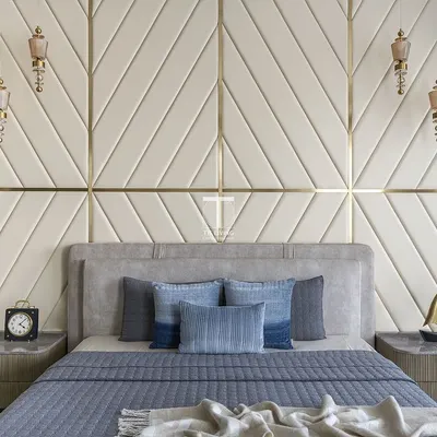 We designed this bedroom with a striking upholstered wall panel in a chevron pattern. The custom bed and floating bedside tables were crafted to create a cohesive and luxurious look, with every detail adding to the room's modern elegance.