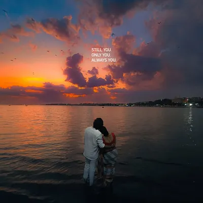 Still you, only you, always you. A romantic shot of a couple standing in the water at sunset, captured on an iPhone.