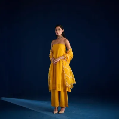A stunning full-length shot for designer Aapro against a custom-painted deep blue cyclorama. This demonstrates how we can create a specific mood to match a collection's color palette.